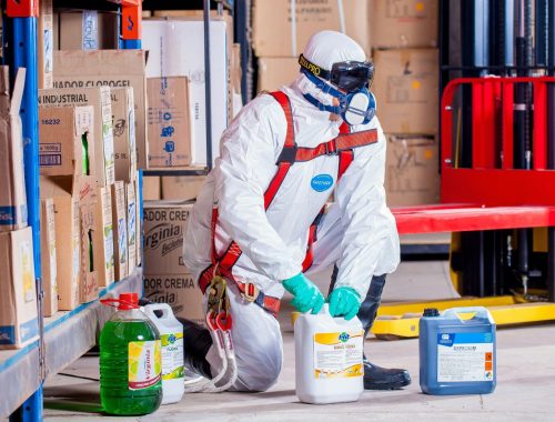 Person Wearing White Suit Holding White Container